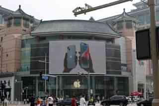 Surveillance cameras are seen near an iPhone advertisement at an Apple store in Beijing, China (REUTERS/Florence Lo)