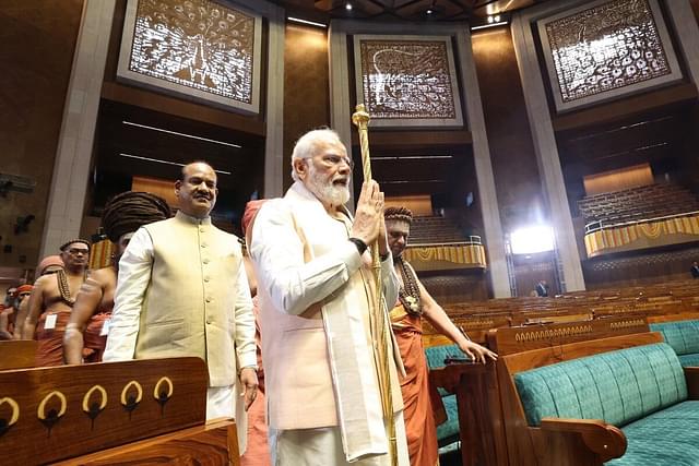 Prime Minister Narendra Modi with 'Sengol' in the Lok Sabha chamber. 