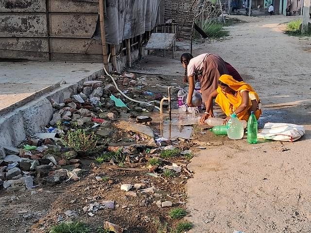 Some of the residents making use another common pipe in Miya Bigha. (Source: Swarajya)