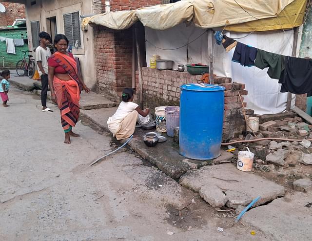 The Blue pipes lying defunct, while residents use the stored water for daily uses. (Source: Swarajya)