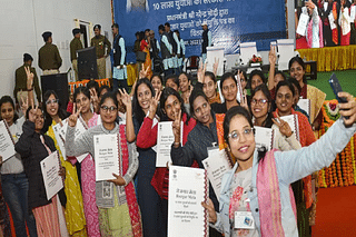 Female candidates show their job appointment letters during a Rozgar Mela at Sambo village in Ranchi.