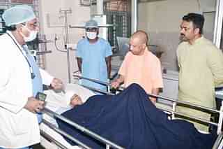 Chief Minister Yogi Adityanath visiting the injured child in the hospital