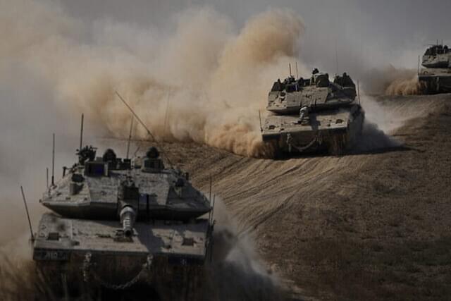 Israeli tanks head toward the Gaza Strip border in southern Israel on 13 October, 2023. (AP Photo/Ariel Schalit)