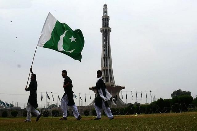 Pakistan citizens with the national flag.