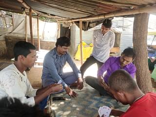 A group of men absorbed in a card game