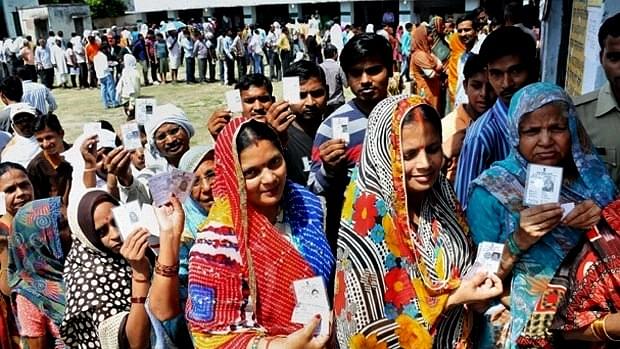 Voters queue up for casting their ballots on the day of polling.