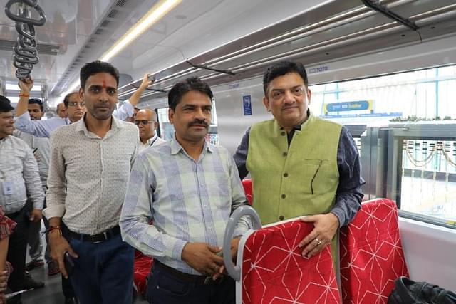 NCRTC MD Vinay Kumar Singh with commuters on the first day commercial run of Namo Bharat.