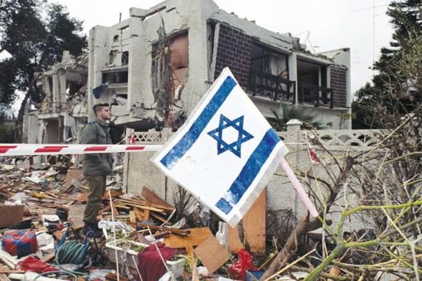 An Israeli flag near the side of destruction.