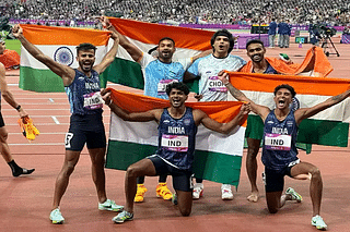 The Asian Games gold medal winning Indian 4*400 metre relay team and javelin throw gold and silver medal winners (centre) Neeraj Chopra and Kishore Kumar Jena.