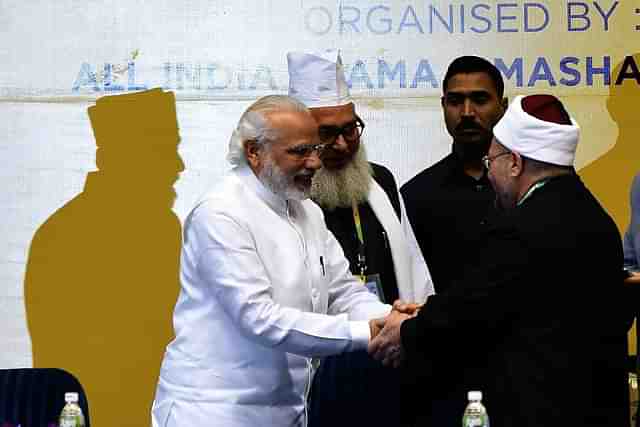 Indian Prime Minister Narendra Modi (L) shakes hands with delegates during the inauguration of World Sufi Forum in New Delhi on March 17, 2016. (Photo credit: PRAKASH SINGH/AFP/Getty Images)