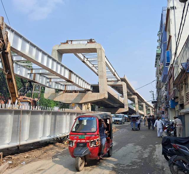 The double decker flyover under construction. The same stretch also has the metro underground. 
(Source: Swarajya)