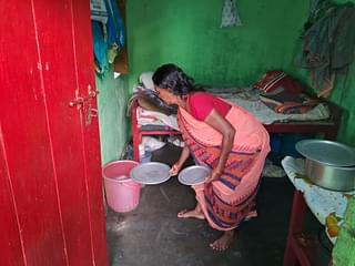 Muniya Devi showing the water buckets she stored for the day. 
(Source: Swarajya)