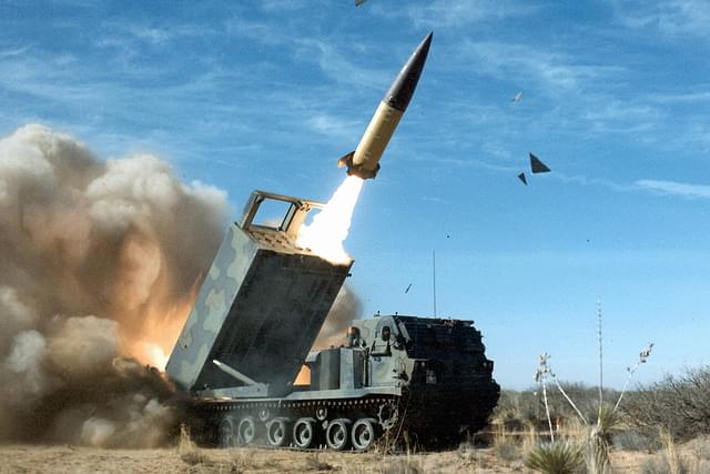 M270 MLRS launcher launching ATACMS missiles. (image via Wikipedia)