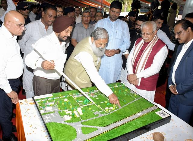 Haryana CM Manohar Lal inspecting the model after laying the foundation stone of the domestic airport in Ambala Cantonment under the UDAN scheme on 15 October 2023