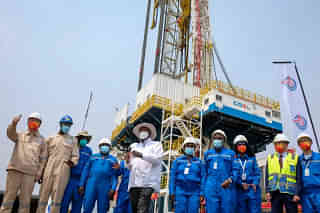 Uganda’s President Yoweri Museveni, centre, with workers at the Kingfisher oilfield. Photo: AP