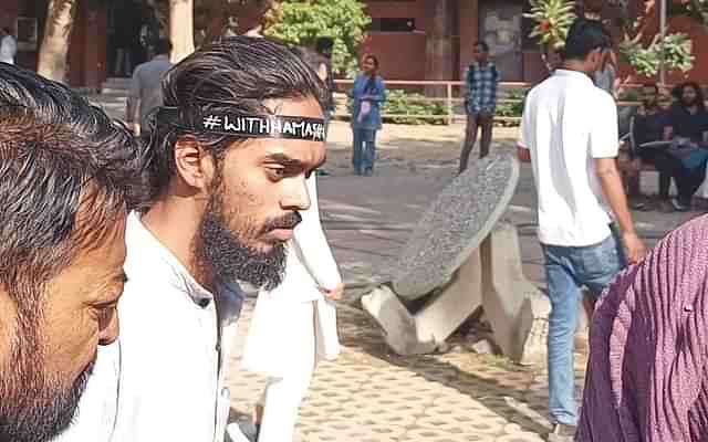 A man wearing ‘With Hamas’ badge on head