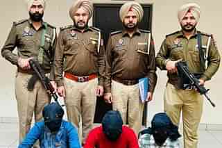 Punjab Police officers with three arrested men