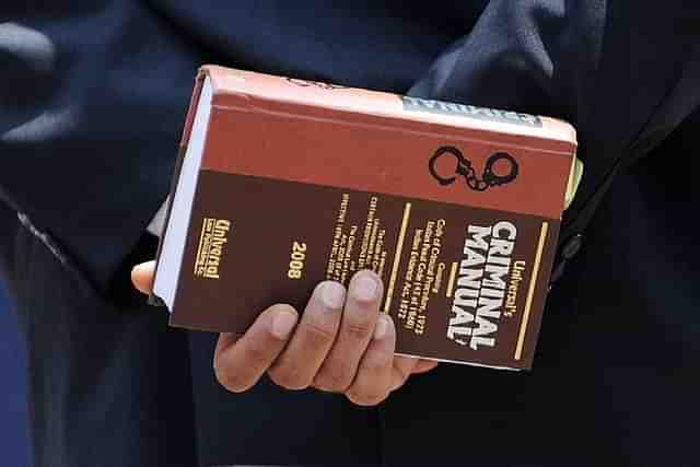 A lawyer holds a criminal manual (INDRANIL MUKHERJEE/AFP/Getty Images)