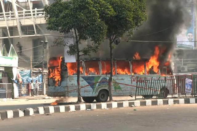 A bus torched by BNP activists in Dhaka on Sunday (5 November).