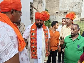 Raja Singh listens to a voter's grievance in Moti Market. (Sharan Setty/Swarajya)