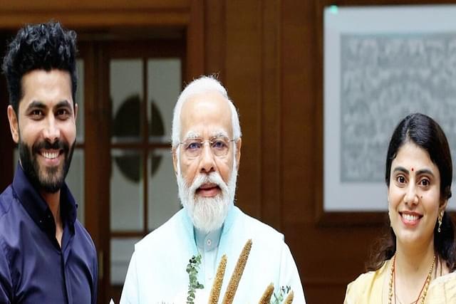 Cricketer Ravindra Jadeja (Left), PM Narendra Modi (Centre), Rivaba Jadeja. (Right)