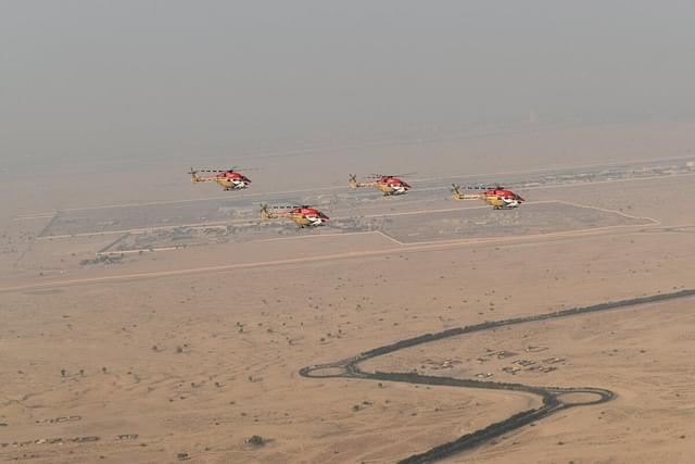 Sarang display team using ALH Dhruv helicopter flying in formation over airspace in Dubai. (Image via X@IAF_MCC)