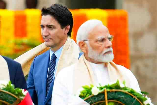 Canada’s Prime Minister Justin Trudeau, left, walks past Indian Prime Minister Narendra Modi as they take part in a wreath-laying ceremony at Raj Ghat.

