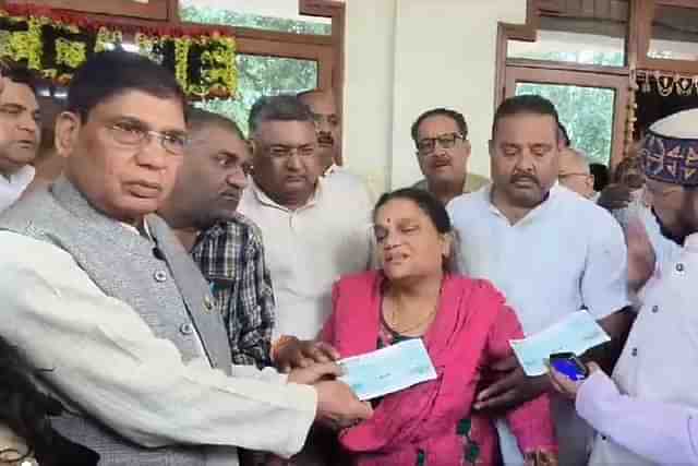 UP Minister with mourning mother (Still from the video of the incident)