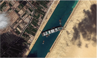 An aerial view of the container ship Ever Given blocking the Suez Canal (Satellite images by FleetMon and Getty Images)