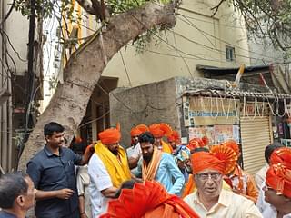 Singh garlanding a Muslim man from his constituency (Sharan Setty/Swarajya)