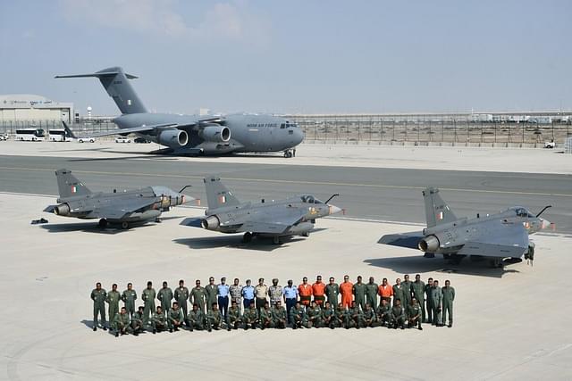 IAF contingent with three Tejas Mk-1 jets and C-17 Globemaster-III transport jet in the background at the Dubai Air Show. (Pic via X @IAF_MCC)