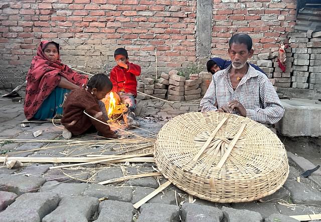 Kamal Dharkar and his family working on a bamboo product 