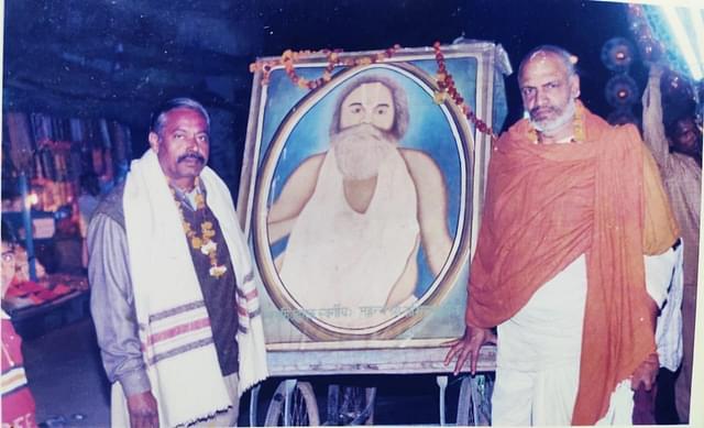 Achyut's father late Gopinath Shukla (left) holding a painting of Mahant Abhiram