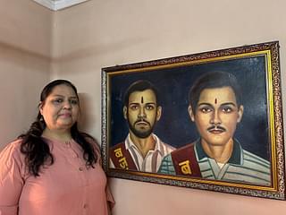 Purnima Kothari stands near a painting of her brothers