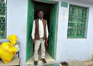 Ansari standing at the gate of his house 