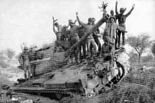 Indian Army personnel celebrate on top of a knocked out Pakistani Patton tank. (Image via Wikipedia)