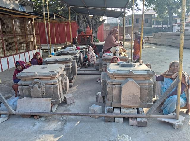 Women working on the stone pedestals for the pillars.  (Source: Swarajya)
