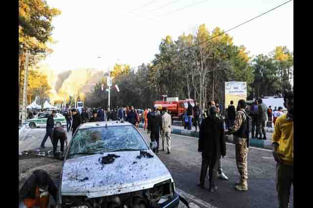 People gather at the site of an explosion in the city of Kerman.