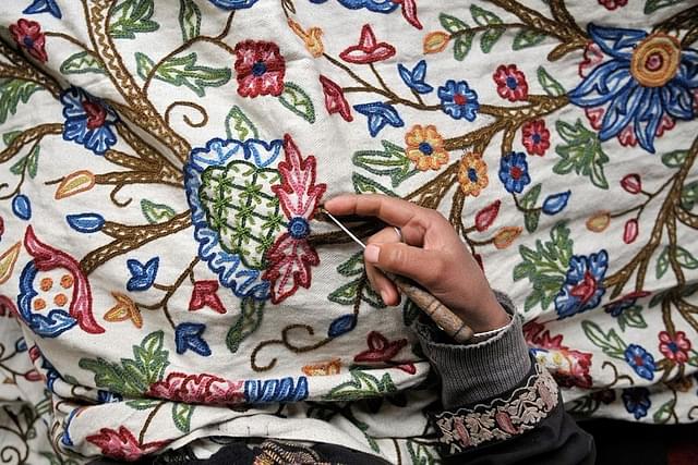 Kashmiri women doing intricate embroidery on window curtains (Waseem Andrabi/ Hindustan Times via Getty images)