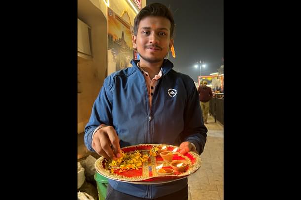 A resident of Ayodhya placing diyas in the streets
