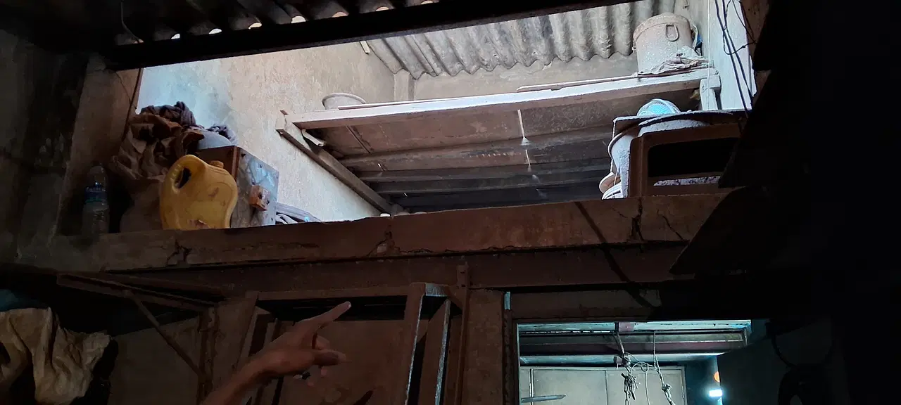 Dinesh pointing at the mezzanines created for his workshop. (Ankit Saxena/Swarajya)