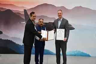 Sanjay Chawla, DG of DGAQA (centre), presenting the certificate of approval to Michael Schoellhorn, CEO of Airbus Defence and Space (R) and Masood Hussainy, Head, Aerostructures and Aeroengines, TASL (L) at the C295 assembly facility in Hyderabad. 