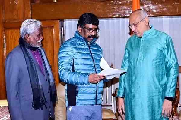 Hemant Soren (middle) submitting his resignation to Governor C P Radhakrishnan (right) while Champai Soren (left) looks on