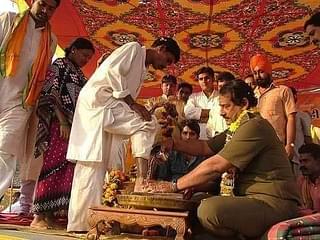 Dilip Singh Judev, Prabal's father, washing the feet of tribals in a ghar wapsi ceremony.