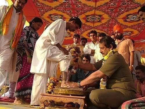 Dilip Singh Judev, Prabal's father, washing the feet of tribals in a ghar wapsi ceremony.
