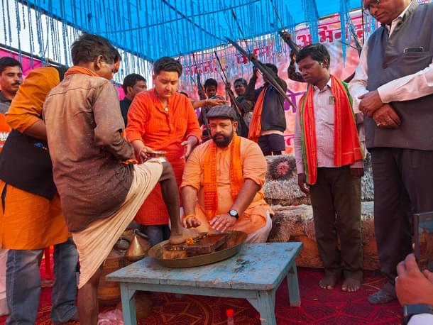 Judev washing the feet of a tribal man.