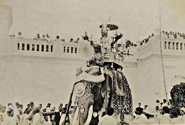 Raja Shri Vijay Bhushan Singh Judev of Jashpur, seated in a howdah atop a caparisoned elephant.
