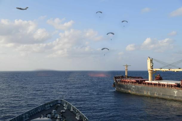 Indian Navy's Marine Commandos (MARCOS) can be seen descending after being paradropped from IAF's C-17 Globemaster-III (visible in the background). (Via ANI)