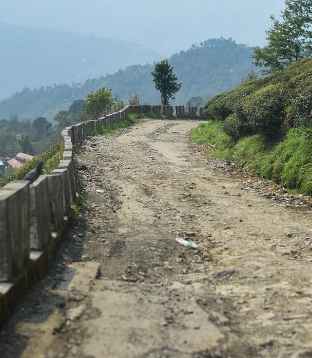 A cratered road inside the Happy Valley Tea Estate. Photo credit: SAYAN SARKAR