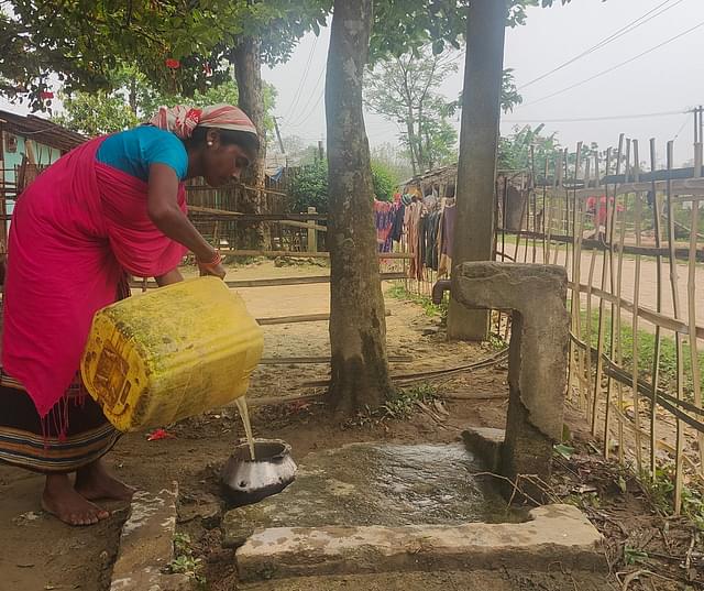 Anamika Goala busy with household work in the courtyard of her house which has a tap water connection.